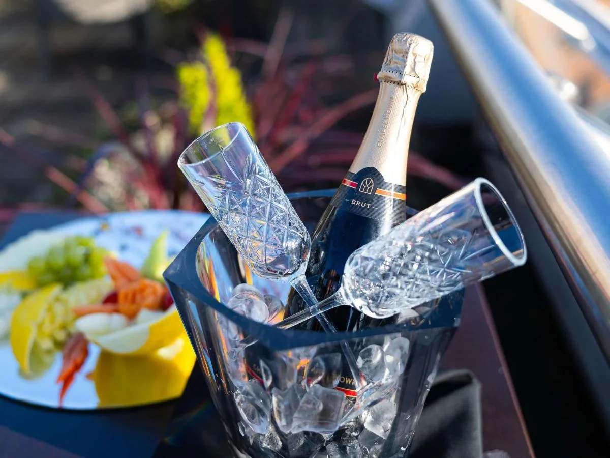 a bottle of champagne and glasses on a table at Novotel Cardiff Centre in Cardiff