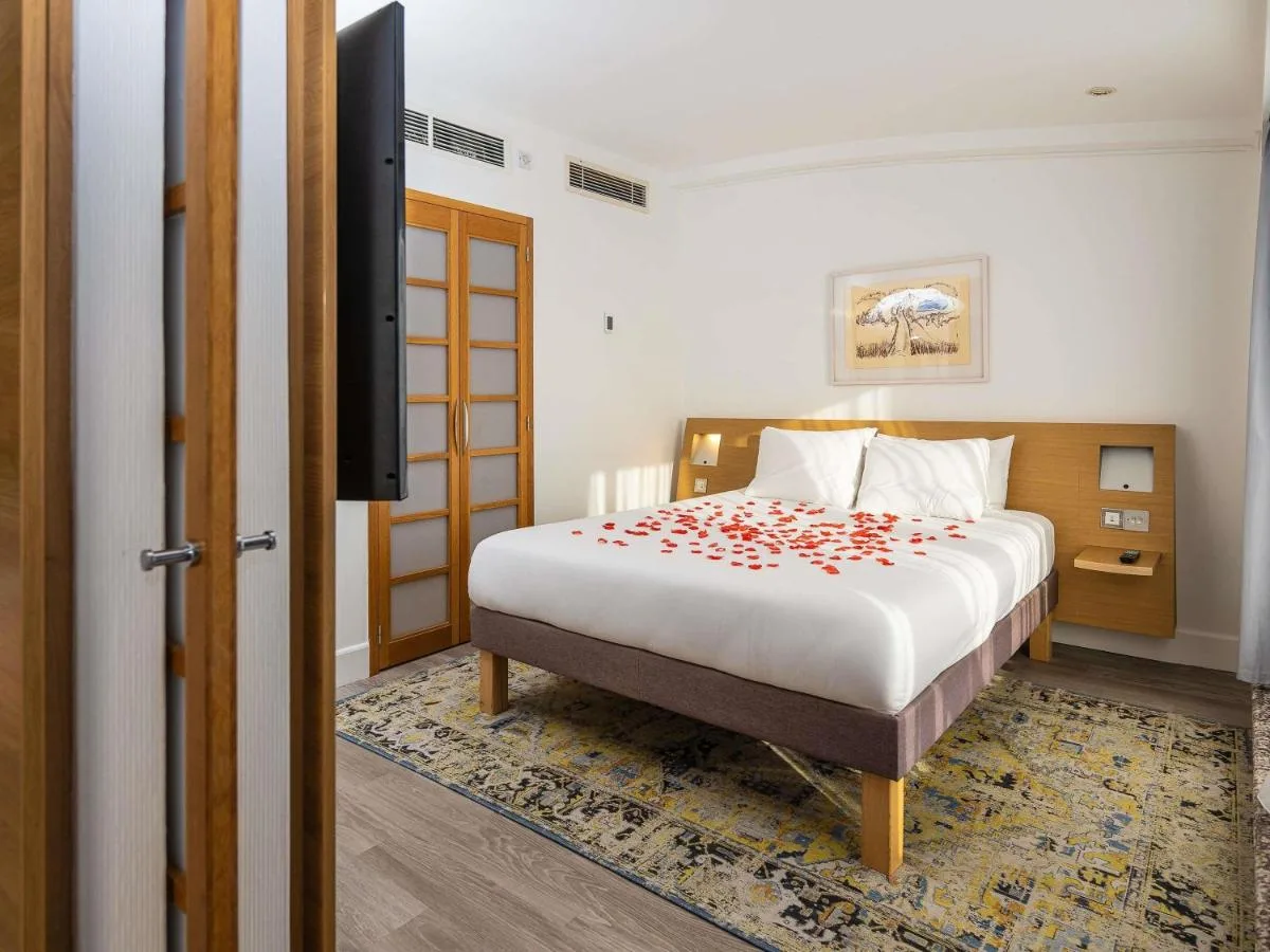 a bedroom with a bed and a television in it at Novotel Cardiff Centre in Cardiff